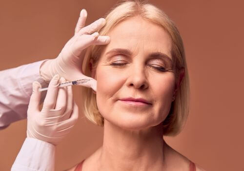 Woman getting botox for TMJ treatment.