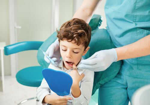 Boy getting a dental exam.