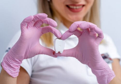 Dentist with floss heart. Heart health and oral health links.
