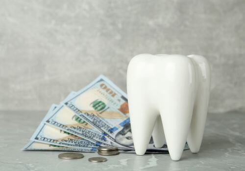 Tooth and $100 bills laid out